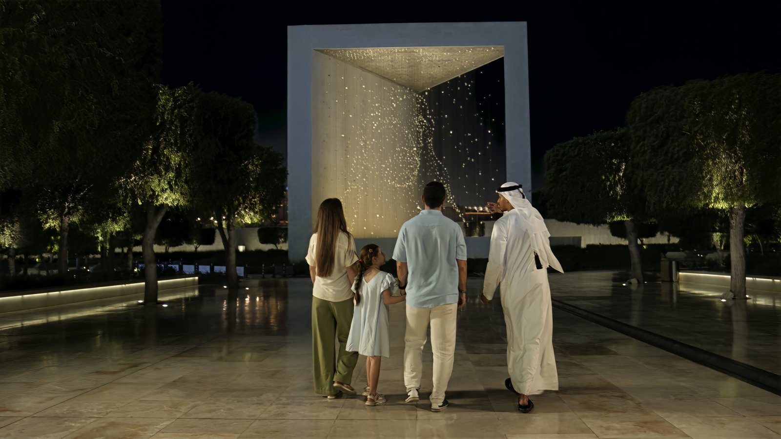 Emirati guide leading visitors through Sheikh Zayed Grand Mosque in Abu Dhabi
