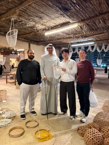 Local Emirati guide with international guests during an authentic Abu Dhabi tour